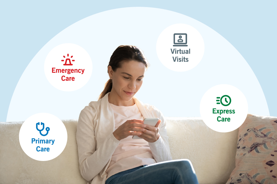 Person sitting on a couch looking at their mobile phone.